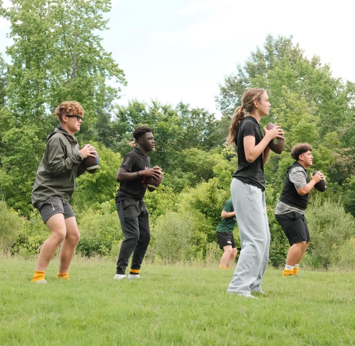 Kennedy Ford in a line of quarterbacks working out with the boys on the TOUR